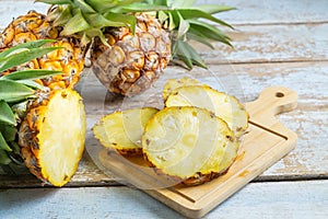 Fresh pineapple fruit sliced Ã¢â¬â¹Ã¢â¬â¹on a wooden cutting board